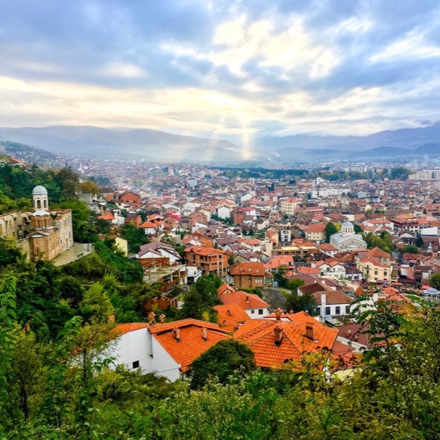Sun rays breaking over the rooftops of Prizren